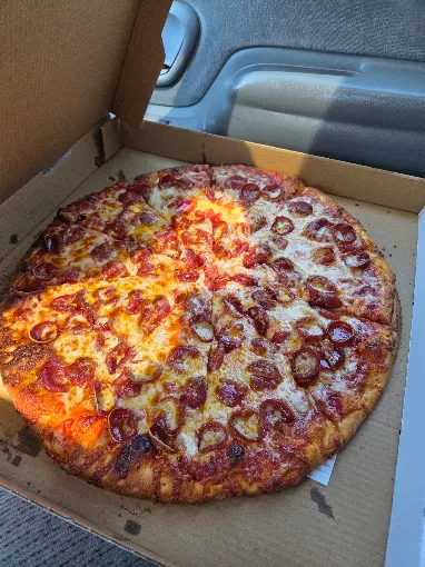 Buscemi's round pepperoni and sausage pizza in a takeout box