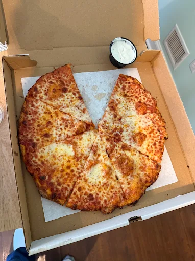 Buscemi's round cheese pizza with a side of ranch