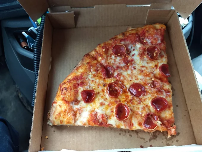 Buscemi's pizza slices in a takeout box