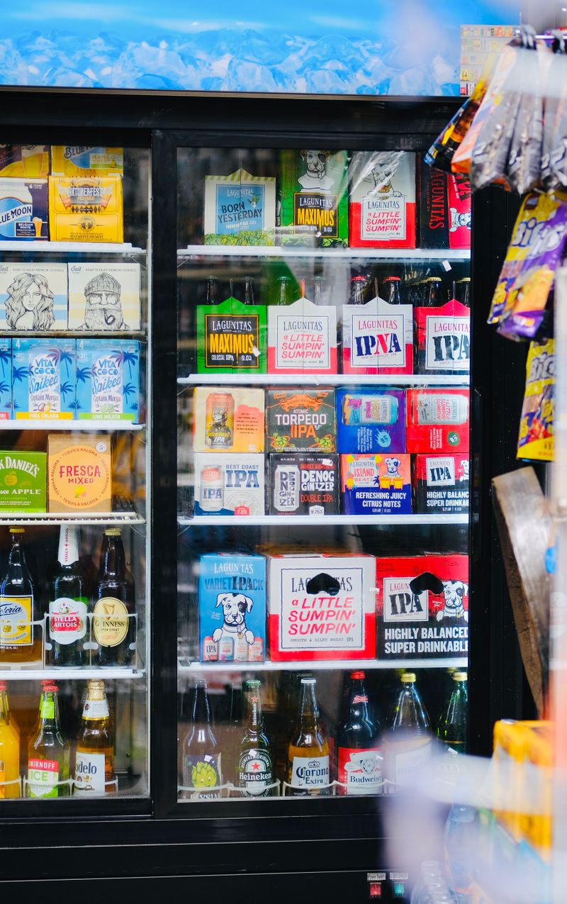Cold beer and wine bottles stocked in a store cooler