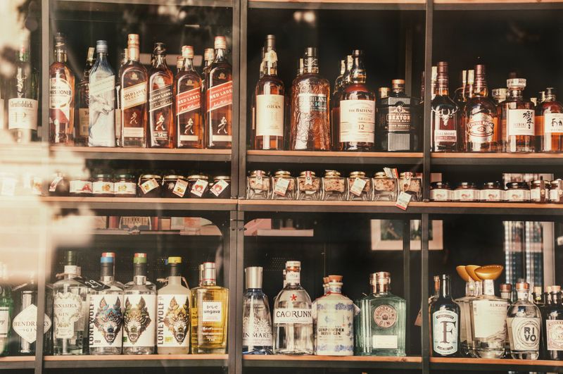 Liquor bottles lined up on store shelves